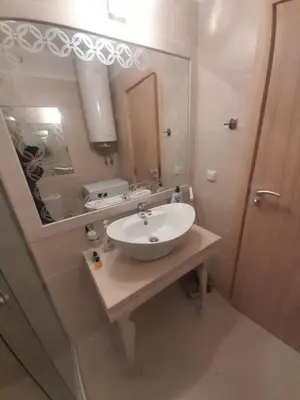a bathroom with a sink and a large mirror at 2 Room Apartment Harmony Suites Komplex in Sunny Beach