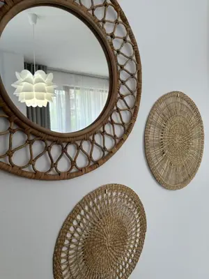 a mirror and three baskets on a wall at Cascadas family apartamant 2 in Sunny Beach