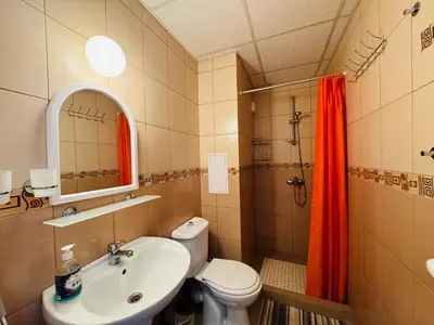 a bathroom with a toilet and a sink and a shower at GRAND KAMELIA B 2,8 Large Studio Sunny Beach in Sunny Beach