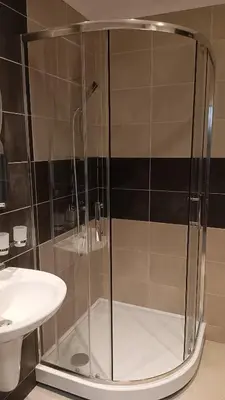 a shower with a glass door next to a sink at Royal Palm Studio, Sveti Vlas in Sveti Vlas