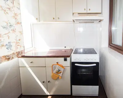 a small kitchen with a stove and a sink at Premium Lazur - Sea garden Burgas - TOP Location 5 min to the Beach in Burgas City