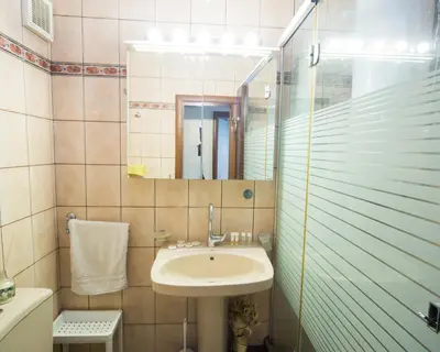 a bathroom with a sink and a mirror at Premium Lazur - Sea garden Burgas - TOP Location 5 min to the Beach in Burgas City