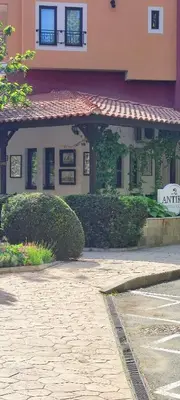 a building with a sign in front of it at Marina in Aheloy