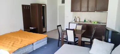 a small room with a kitchen and a table and chairs at Marina in Aheloy