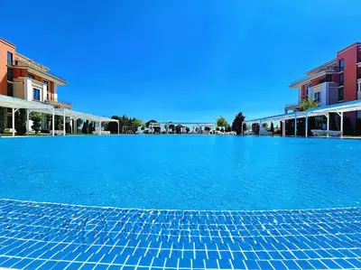 a large blue swimming pool with blue water at Prestige Fort Beach apartment in Sveti Vlas