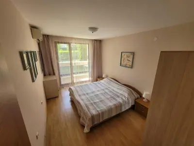 a bedroom with a bed and a large window at Prestige Fort Beach apartment in Sveti Vlas