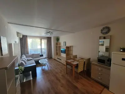 a living room with a couch and a table at Prestige Fort Beach apartment in Sveti Vlas