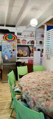 a dining room with a table and a refrigerator at каравана ТРОПИК-ЕКЗОТИК А 17 in Sozopol