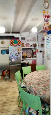 a room with a table and chairs and a refrigerator at каравана ТРОПИК-ЕКЗОТИК А 17 in Sozopol