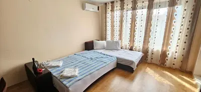 a small bedroom with a bed and a window at Sunny Day Pomorie in Pomorie