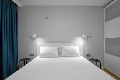 a white bed with two pillows on top of it at The little things apt - Parking & Own EV Chаrgеr by Flat Mаnаger in Burgas City