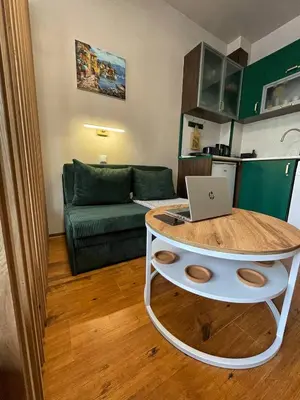 a living room with a table with a laptop on it at GreenStudio w Sveti Vlas in Sveti Vlas