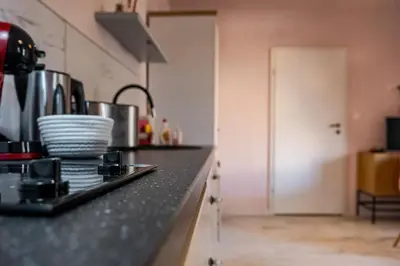 a kitchen with a counter top with dishes on it at Flamingo Top Center Apartment in Varna City