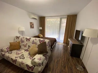 a living room with a couch and a bed at Studio Kristina in Pomorie
