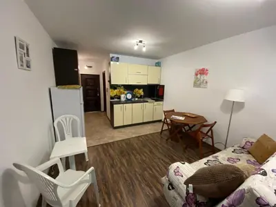 a living room with a couch and a kitchen at Studio Kristina in Pomorie