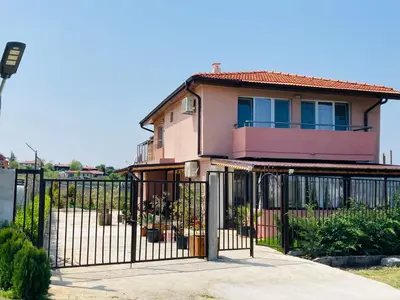 a pink house with a gate in front of it at Saint Anastasia lozenets in Lozenets