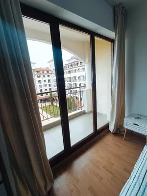 a room with a large window with a view of a building at Bulgapart Obzor in Obzor