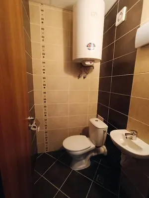 a small bathroom with a toilet and a sink at Bulgapart Obzor in Obzor