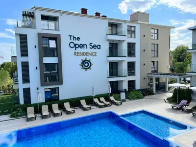 a building with a swimming pool in front of a building at Double studio Petra B2-5 in Byala