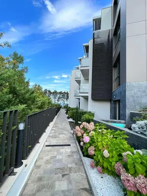 a walkway in front of a building with flowers at Double studio Petra B2-5 in Byala