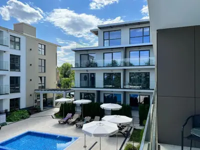 an apartment building with tables and a swimming pool at Double studio Petra B2-5 in Byala