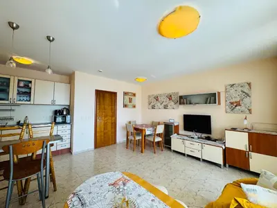 a living room with a kitchen and a dining room at LAZUR 1 Apartment 7- 5 Sveti Vlas in Sveti Vlas