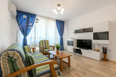 a living room with a couch and a table at Infinity view 2 Shkorpilovci in Shkorpilovtsi