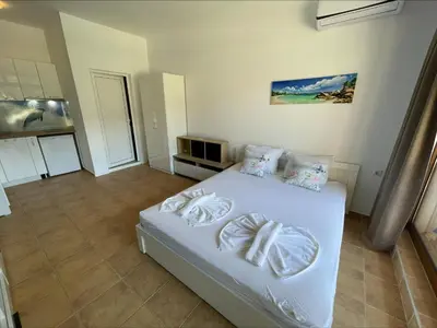 a bedroom with a white bed in a room at Menada Kalia Apartments in Sunny Beach
