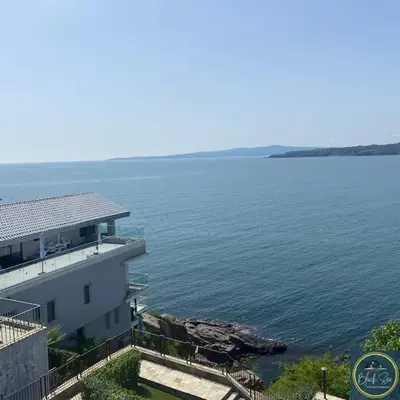 a white building next to a large body of water at 2 Bed Suite, Exclusive Sea Views in Sozopol