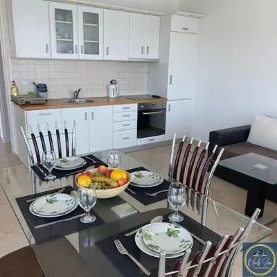 a kitchen with a table with a bowl of fruit on it at 2 Bed Suite, Exclusive Sea Views in Sozopol
