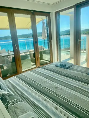 a bedroom with a bed with a view of the ocean at 2 Bed Suite, Exclusive Sea Views in Sozopol