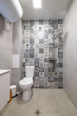a bathroom with a toilet and a tile wall at Cozy Central Apartment Varna & Parking - subject to availability in Varna City