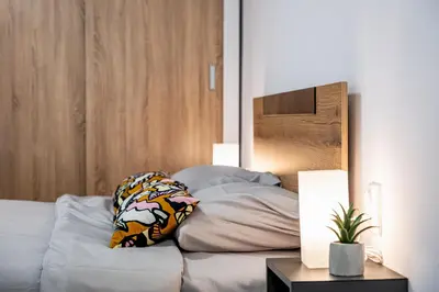 a bedroom with a bed with two pillows on it at Cozy Central Apartment Varna & Parking - subject to availability in Varna City