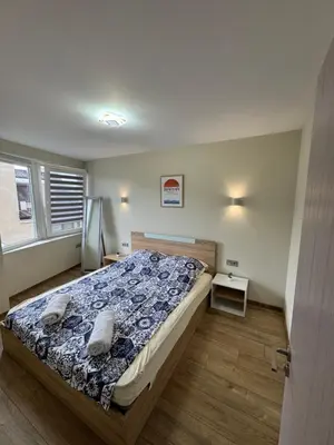 a bedroom with a bed with a blue comforter at Sea Treasure in Varna City