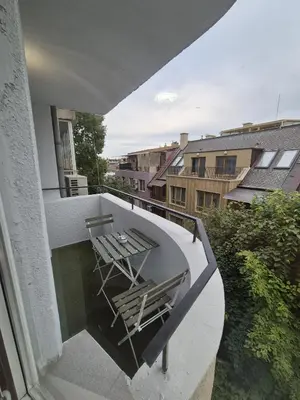 a balcony with two chairs and a table on it at Sea Treasure in Varna City