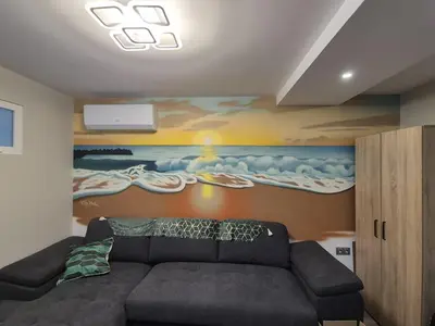 a living room with a couch and a painting at Sea Treasure in Varna City