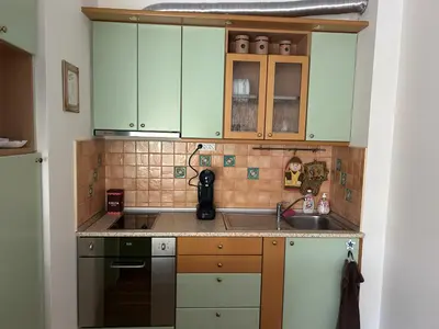a kitchen with green cabinets and a sink at Nesebar City Apartment in Nesebar
