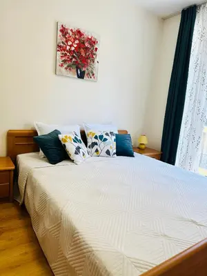 a bedroom with a bed with pillows on it at Vacation apartments Daneli in Sunny Beach