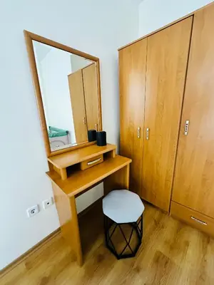 a dressing table with a mirror and a stool at Vacation apartments Daneli in Sunny Beach
