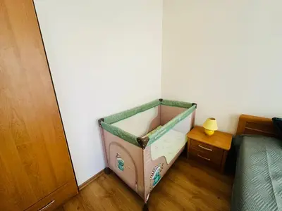 a small bed in a corner of a bedroom at Vacation apartments Daneli in Sunny Beach