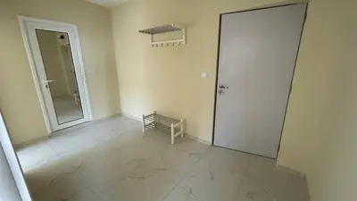 an empty room with a door and a mirror at Zigrabay lovely appartments in Primorsko