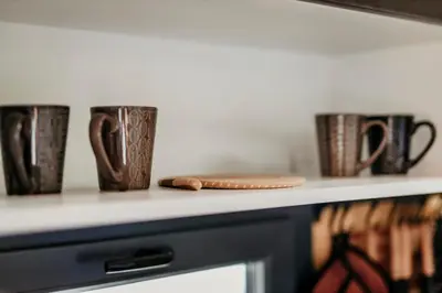 a row of coffee cups sitting on a counter at Lion's Forest in Atiya
