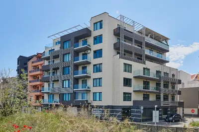 a tall apartment building with balconies on a hill at Sea view Apartment Pomorie in Pomorie