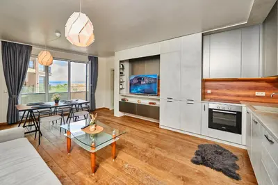 a living room with a couch and a table at Sea view Apartment Pomorie in Pomorie