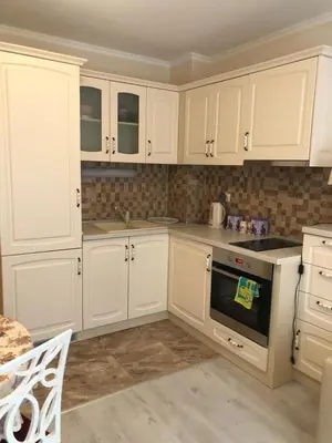 a white kitchen with white cabinets and an oven at Apartment Alex Sveti Vlas in Sveti Vlas