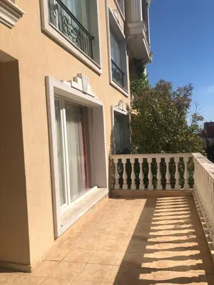 a building with a balcony and a fence at Apartment Alex Sveti Vlas in Sveti Vlas