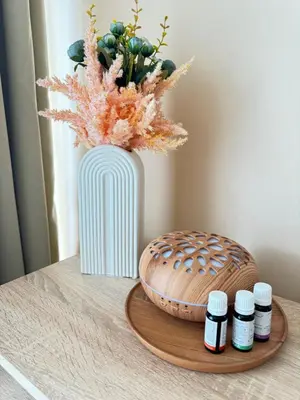 a table with a vase and three bottles of pills at MaYana Beach Appartament in Burgas City