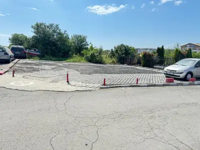 a parking lot with a road with cars parked at MaYana Beach Appartament in Burgas City