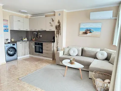 a living room with a couch and a table at MaYana Beach Appartament in Burgas City