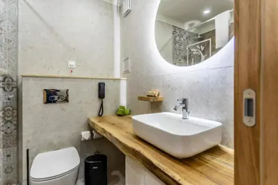 a bathroom with a sink and a toilet at Natura All Seasons Boutique Hotel in Burgas City